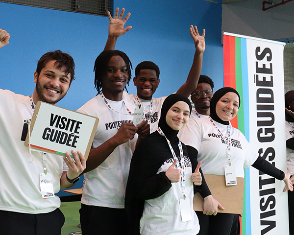 Group of enthusiastic students holding a sign: Guided Tours